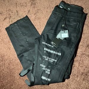 Paint splattered jeans with multiple font stitchings and utility pants features.